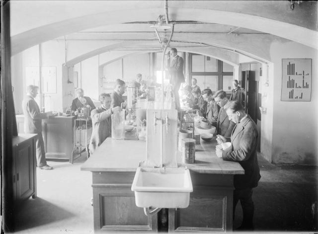 Students in one of the chemistry laboratories, 1920s. A very technically challenging photograph, due to the contrasts of lighting. school, zemědělství, laboratoř